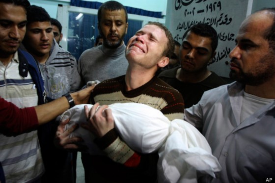 BBC journalist Jihad Masharawi carries his son’s body at a Gaza hospital. (Associated Press)